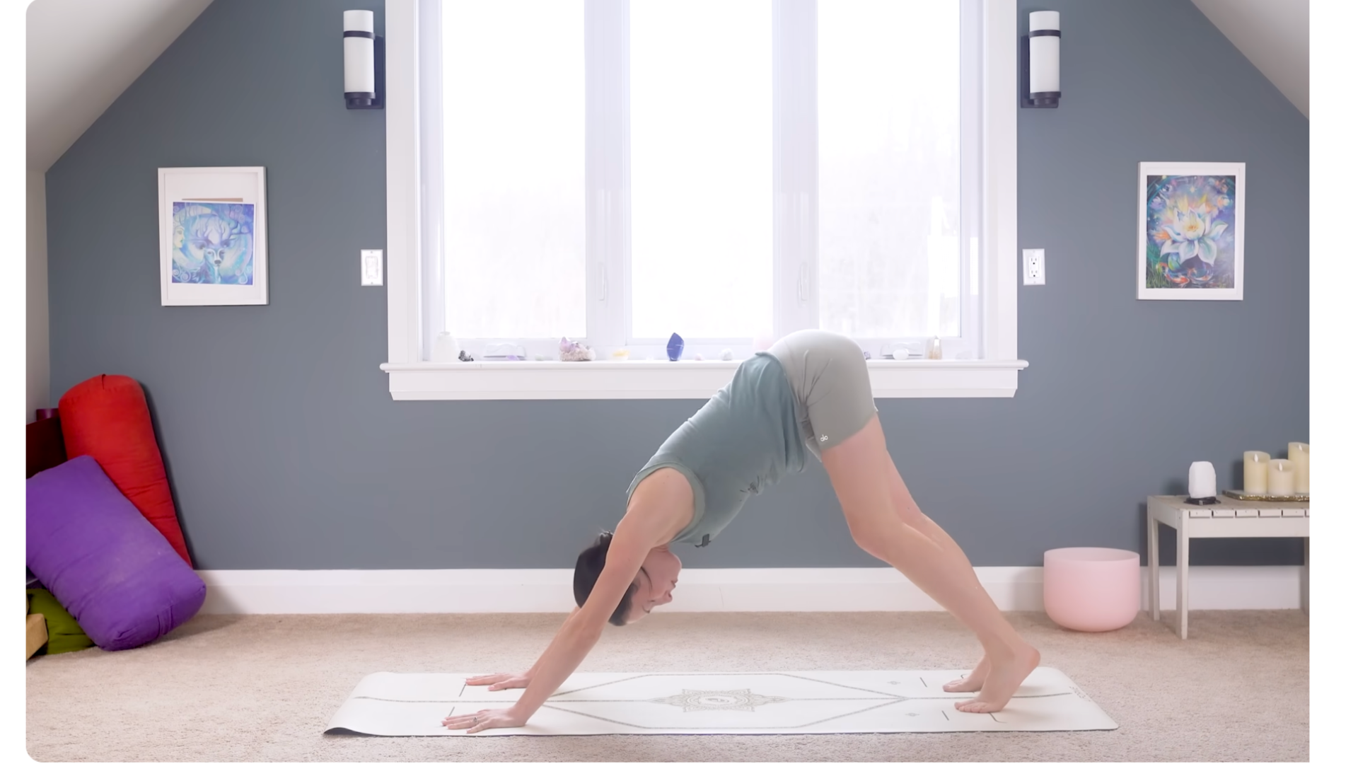 Woman on a yoga mat in Downward-Facing Dog